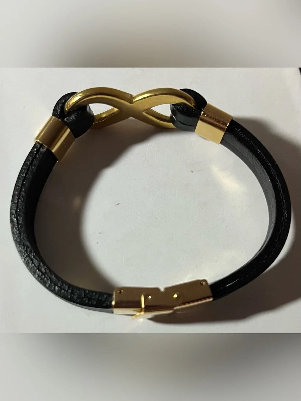 Black Faux Leather Bracelet with Gold tone Infinity Link, and hardware. (NWOT)